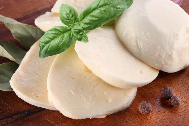 slices of mozzarella cheese on a table ready for hamsters