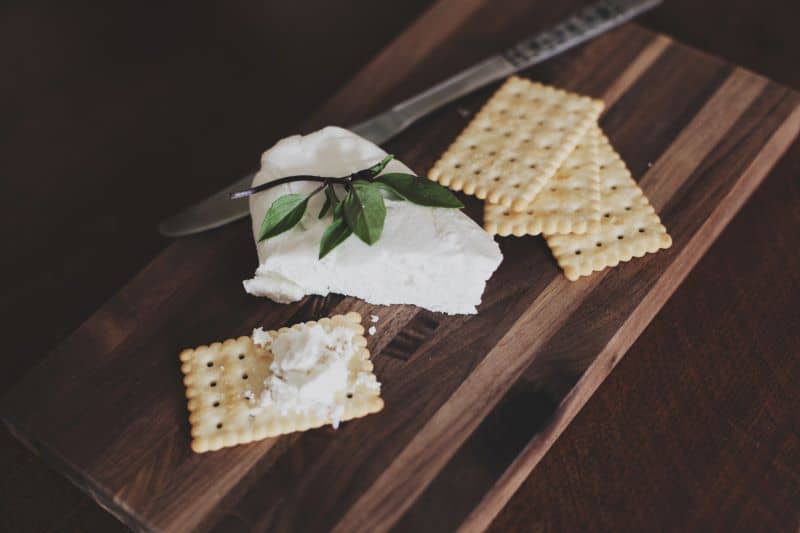 graham crackers with cheese on a chopping board