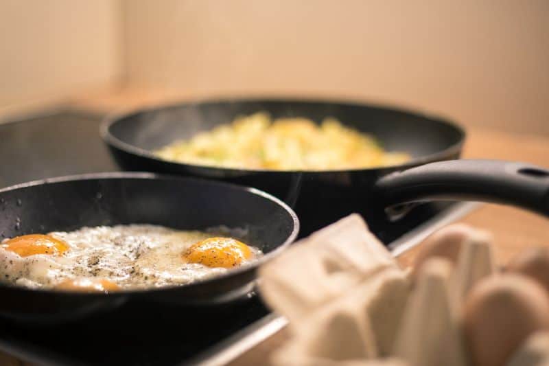 fried eggs being made as many seek an answer to "can hamsters eat fried eggs?"