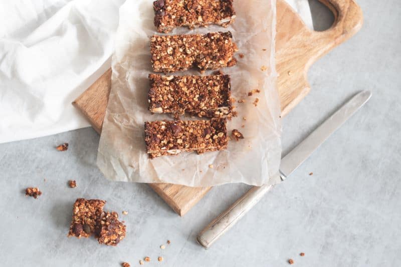 granola bars on a wooden board makes you wonder "can hamsters eat granola bars?"