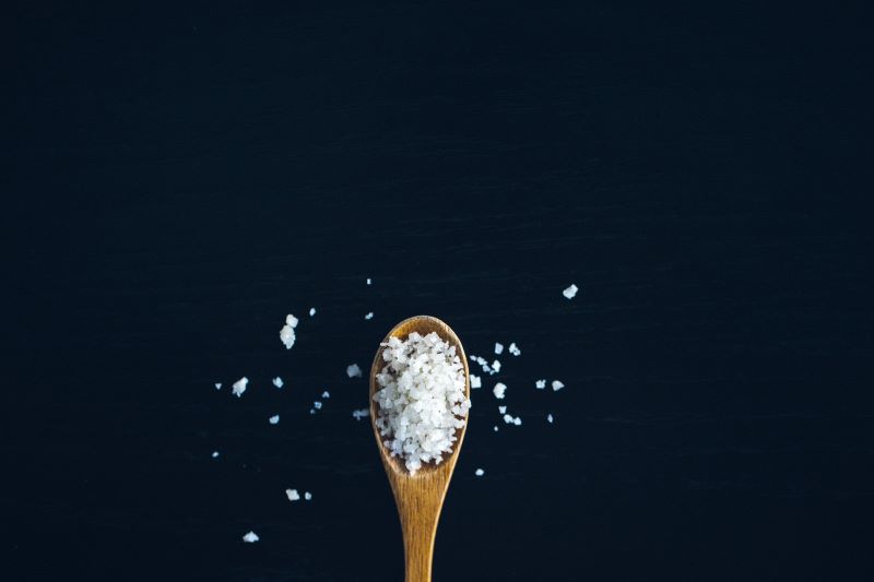 salt on a wooden spatula