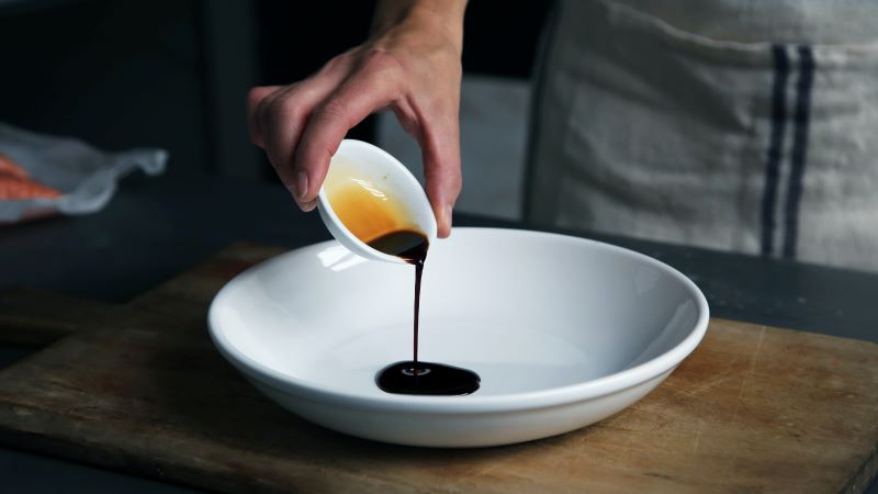 vinegar being poured into a bowl
