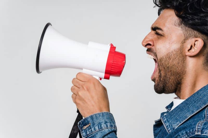 man shouting into a megaphone