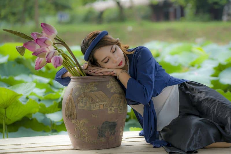 woman resting on a claypot