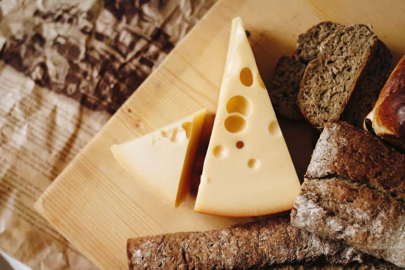 slices of cheese on a table but Can Hedgehogs Eat Cheese?